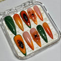 Set of artificial nails in a clear case with a brand name on a light gray background